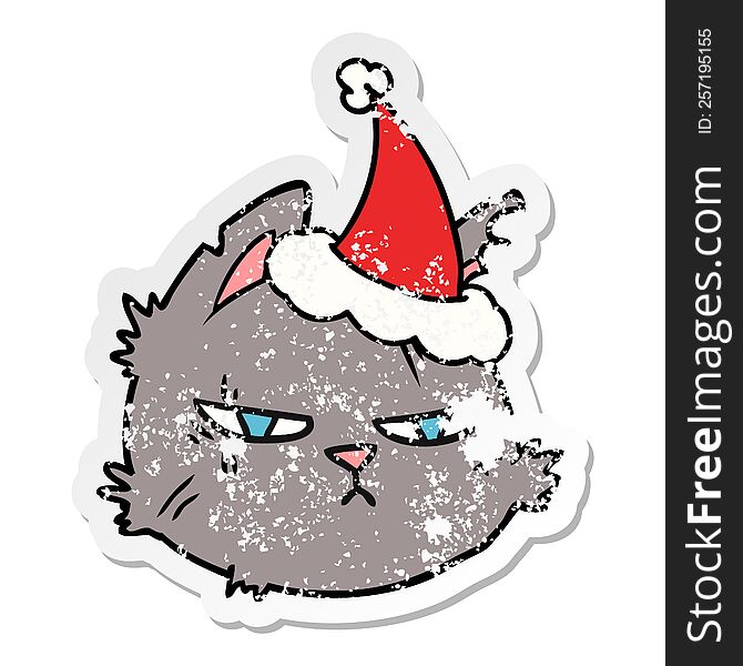 Distressed Sticker Cartoon Of A Tough Cat Face Wearing Santa Hat