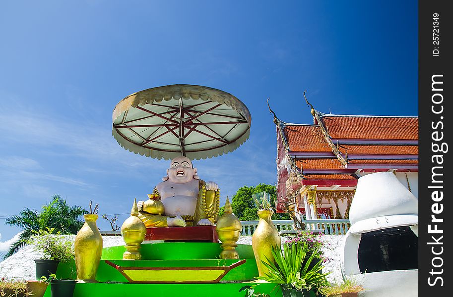 The smile buddha in Thai temple with blue sky, Rayong, Thailand. The smile buddha in Thai temple with blue sky, Rayong, Thailand