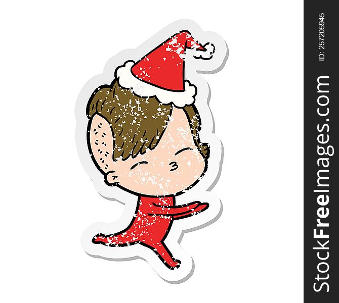 Distressed Sticker Cartoon Of A Girl In Onesie Wearing Santa Hat