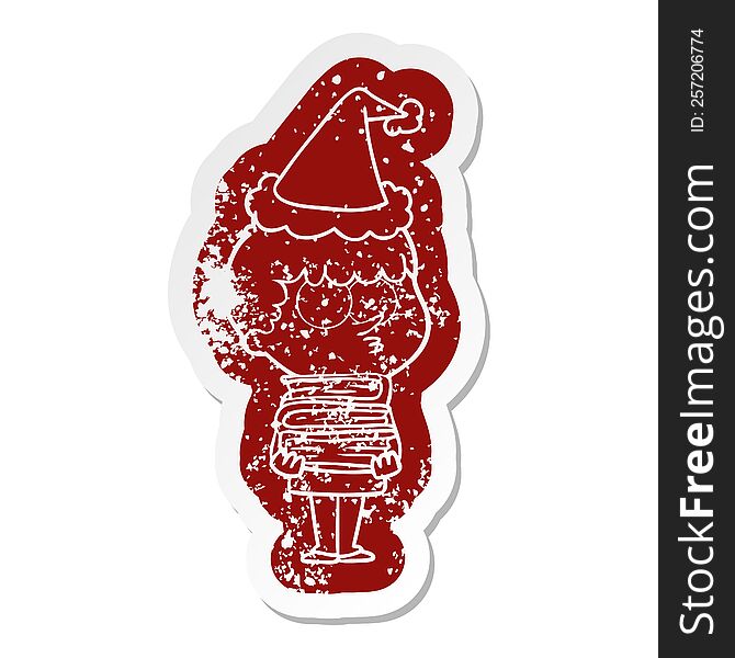 cartoon distressed sticker of a curious boy with lots of books wearing santa hat