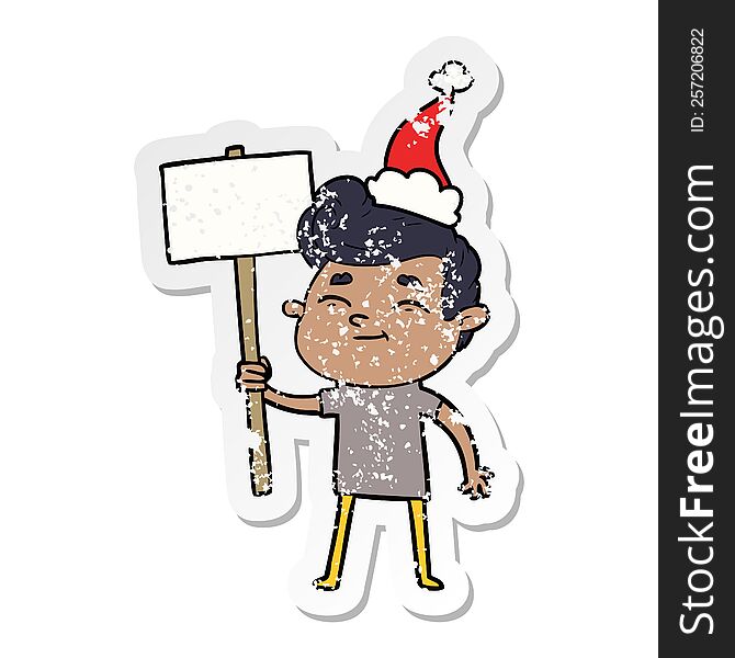 Happy Distressed Sticker Cartoon Of A Man With Sign Wearing Santa Hat