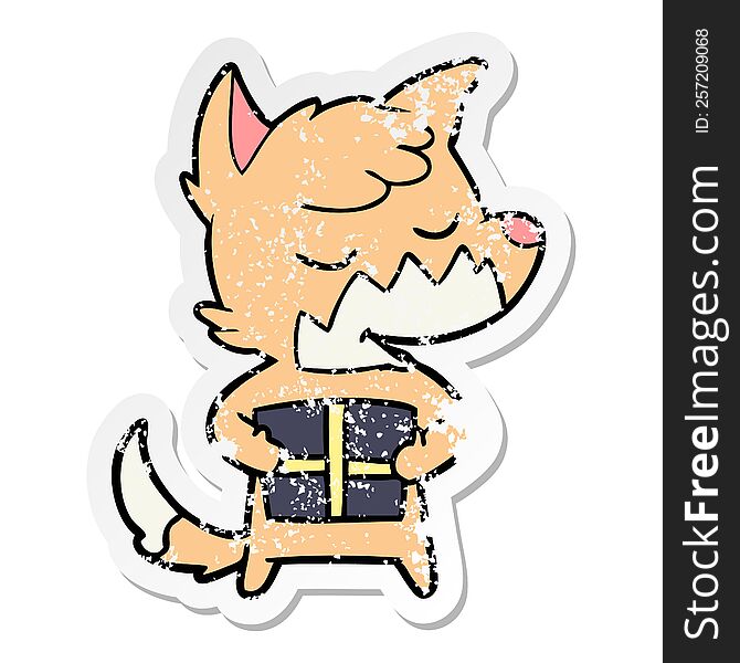 Distressed Sticker Of A Friendly Cartoon Fox With Christmas Present