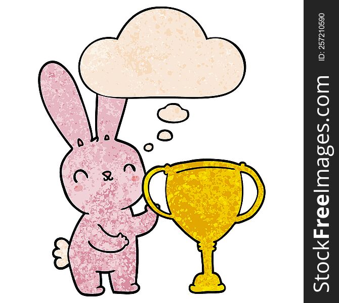 cute cartoon rabbit with sports trophy cup with thought bubble in grunge texture style. cute cartoon rabbit with sports trophy cup with thought bubble in grunge texture style