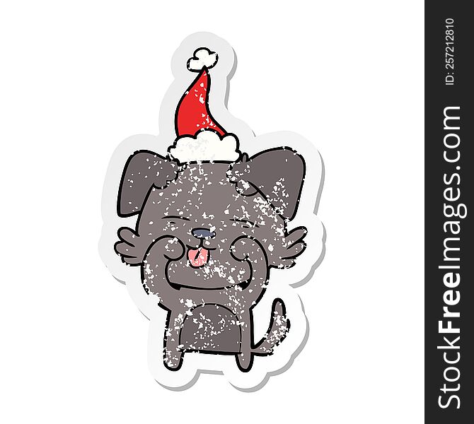 Distressed Sticker Cartoon Of A Dog Rubbing Eyes Wearing Santa Hat