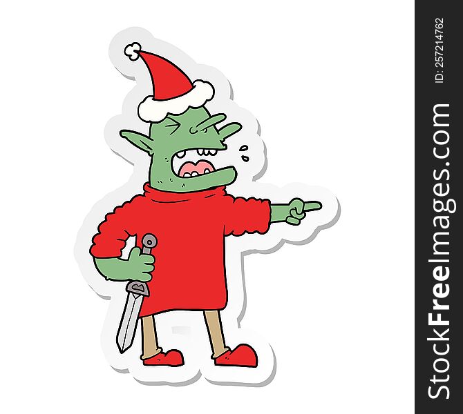 hand drawn sticker cartoon of a goblin with knife wearing santa hat