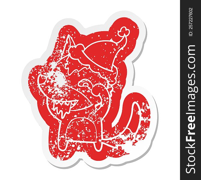 quirky cartoon distressed sticker of a hungry wolf wearing santa hat