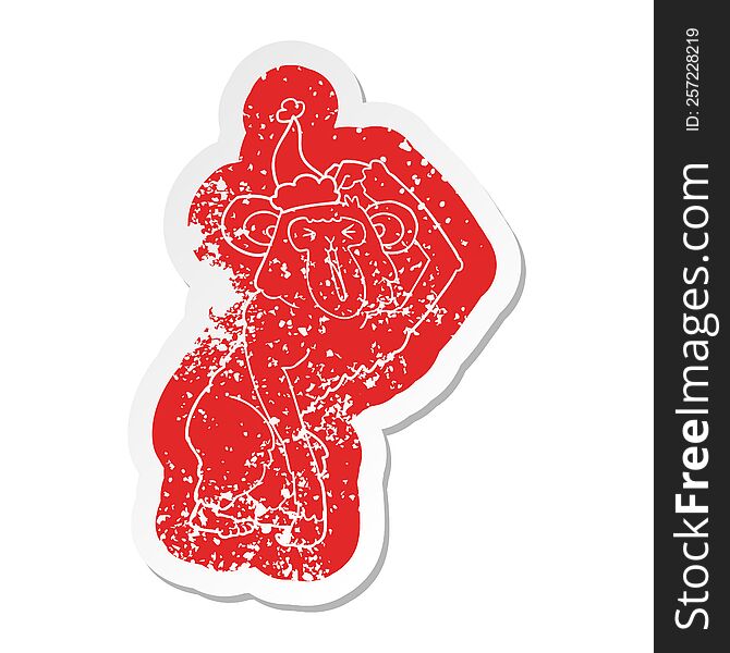 Cartoon Distressed Sticker Of A Chimp Scratching Head Wearing Santa Hat