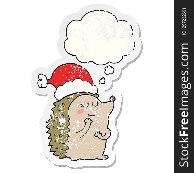 cartoon hedgehog wearing christmas hat with thought bubble as a distressed worn sticker