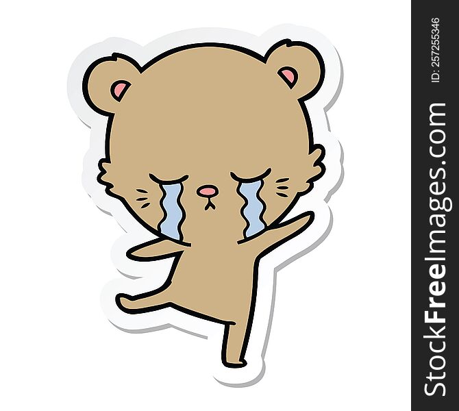 sticker of a crying cartoon bear balancing