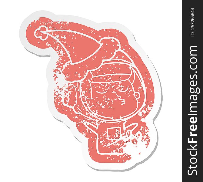 Cartoon Distressed Sticker Of A Confident Astronaut Wearing Santa Hat