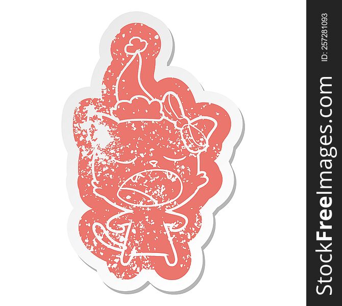 quirky cartoon distressed sticker of a yawning cat wearing santa hat