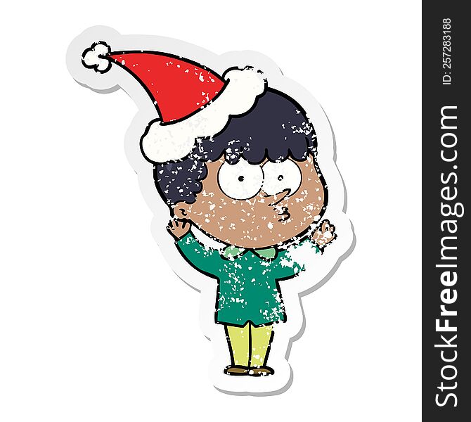 distressed sticker cartoon of a curious boy wearing santa hat