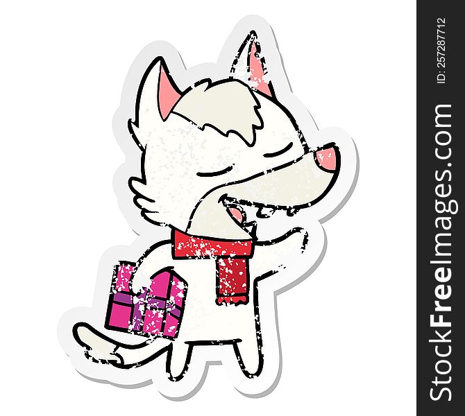Distressed Sticker Of A Cartoon Wolf With Christmas Present Laughing