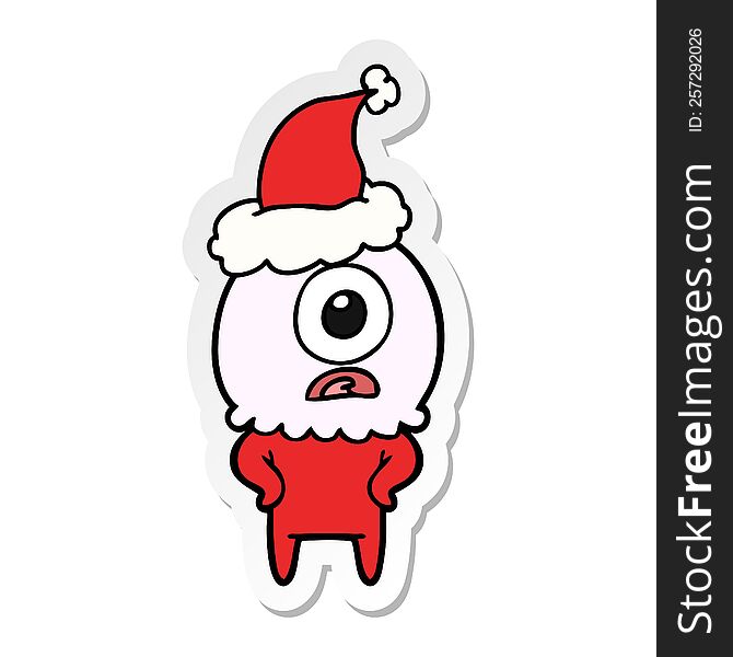 Sticker Cartoon Of A Cyclops Alien Spaceman Wearing Santa Hat