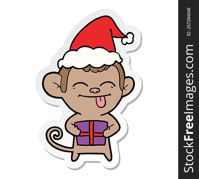 funny hand drawn sticker cartoon of a monkey with christmas present wearing santa hat