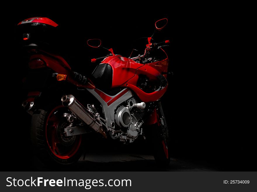 Red sports motorcycle in the dark. Red sports motorcycle in the dark