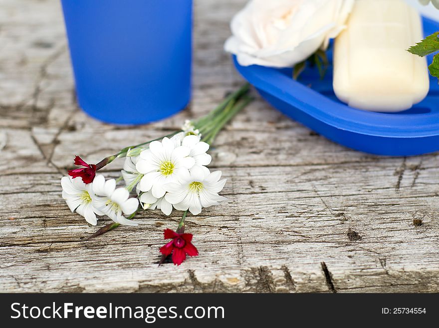 Spa on the pier, red and white flowers, soap and mug. Spa on the pier, red and white flowers, soap and mug