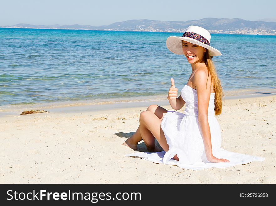 Happy young beautiful woman  on the beach