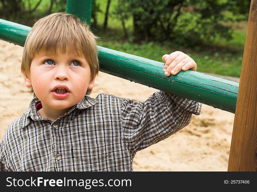 Little boy plays on the playground. Little boy plays on the playground