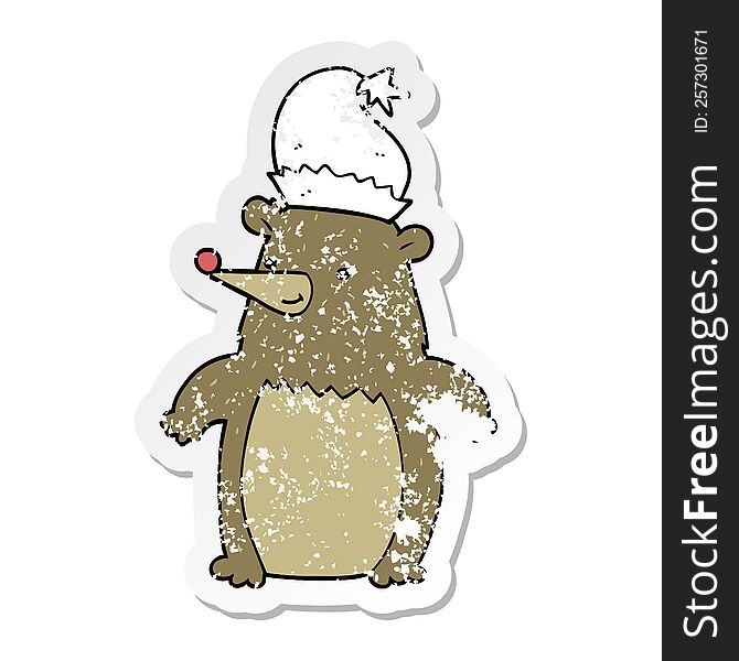 Distressed Sticker Of A Cartoon Bear Wearing Christmas Hat