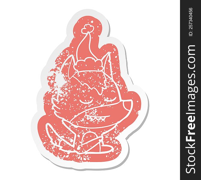Friendly Cartoon Distressed Sticker Of A Wolf Sitting Wearing Santa Hat