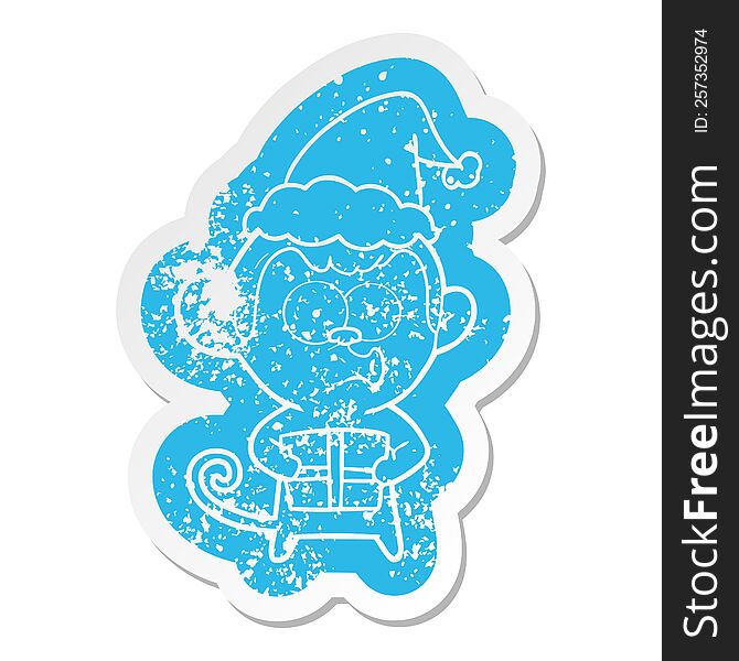 cartoon distressed sticker of a christmas monkey wearing santa hat