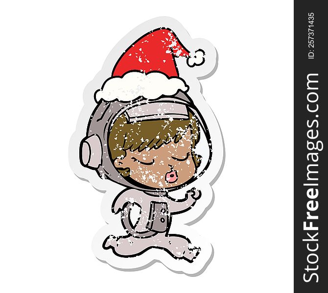 hand drawn distressed sticker cartoon of a pretty astronaut girl running wearing santa hat