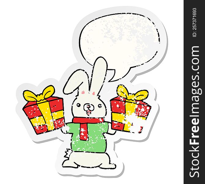 cartoon rabbit with christmas presents with speech bubble distressed distressed old sticker. cartoon rabbit with christmas presents with speech bubble distressed distressed old sticker