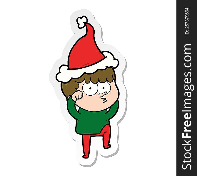 hand drawn sticker cartoon of a curious boy rubbing eyes in disbelief wearing santa hat