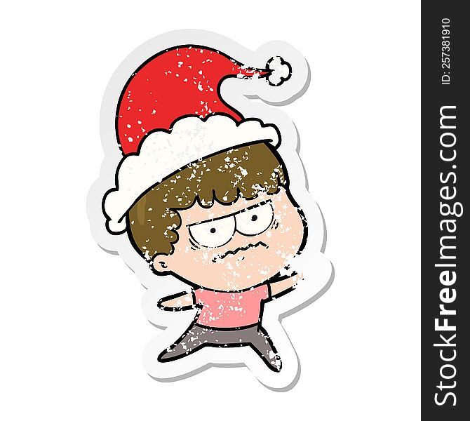hand drawn distressed sticker cartoon of a annoyed man wearing santa hat