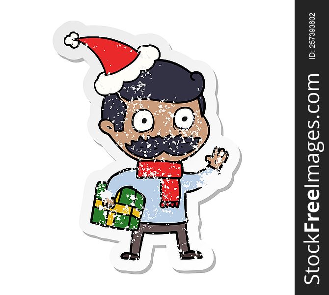 hand drawn distressed sticker cartoon of a man with mustache and christmas present wearing santa hat