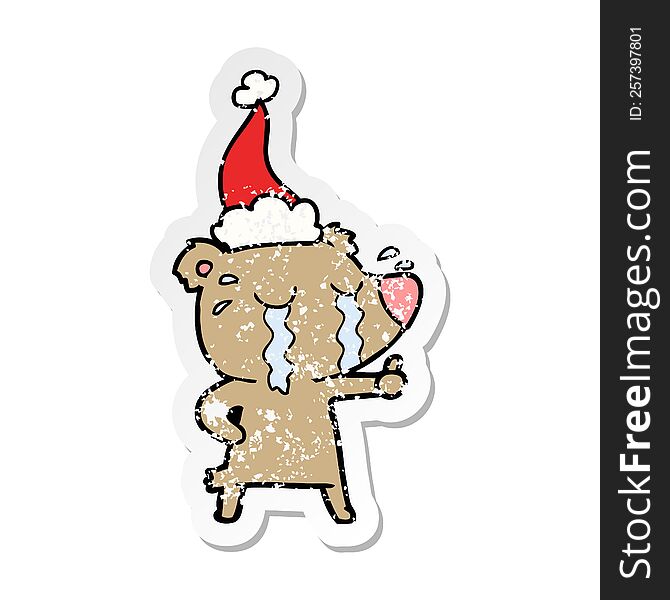 Distressed Sticker Cartoon Of A Crying Bear Wearing Santa Hat