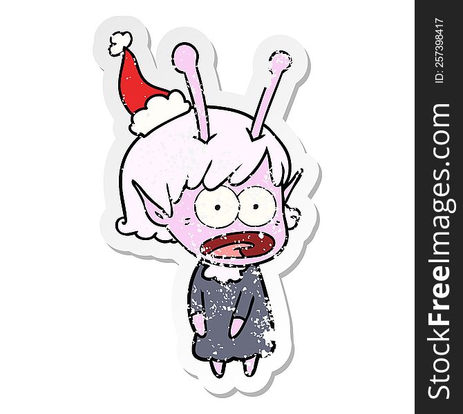 Distressed Sticker Cartoon Of A Shocked Alien Girl Wearing Santa Hat