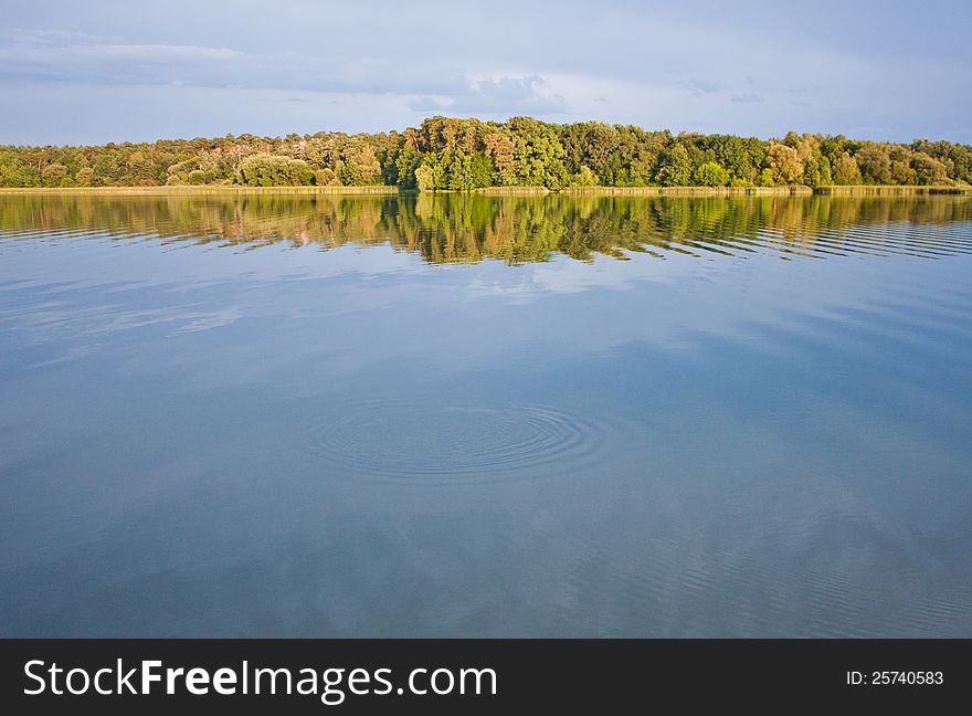 The river with white clouds reflecting in its waters.