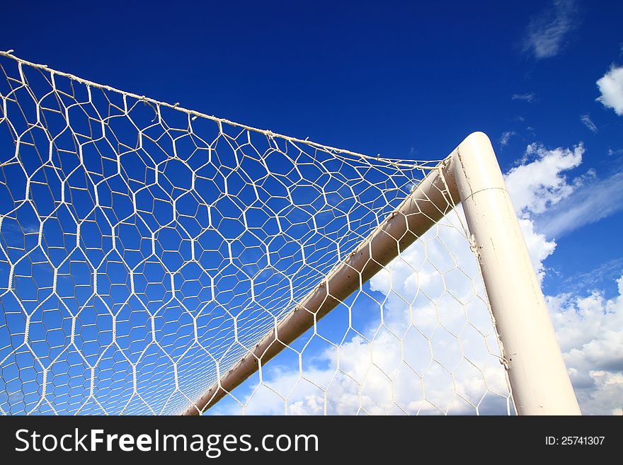 Soccer goal corner with net and blue sky with clouds. Soccer goal corner with net and blue sky with clouds