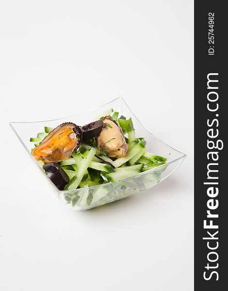 Mouthwatering sea food salad with cucumbers olives and mussel