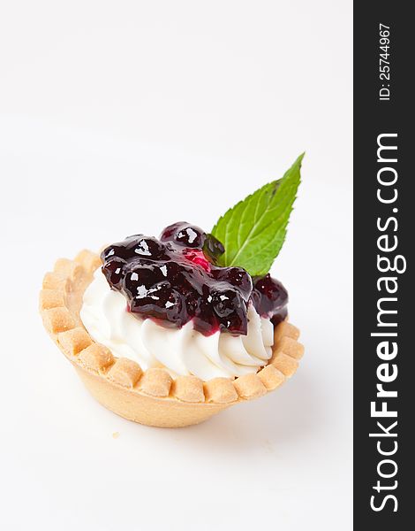 Deliscious blueberry pie with creme and menthol leaf. Deliscious blueberry pie with creme and menthol leaf