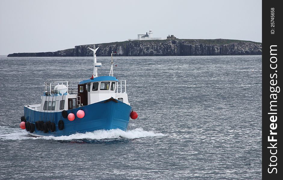 A Boat Returning to Harbour Past the Lighthouse. A Boat Returning to Harbour Past the Lighthouse.