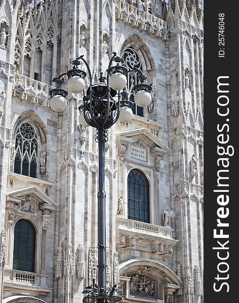 Ancient gothic lam post in front of the duomo of Milan. Ancient gothic lam post in front of the duomo of Milan