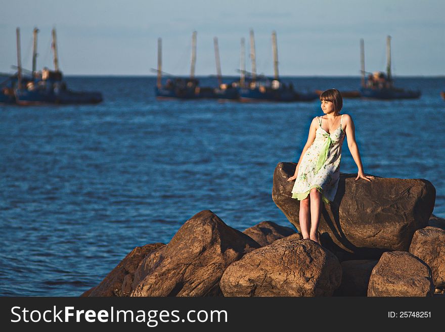 Beautiful lonely girl on the lake