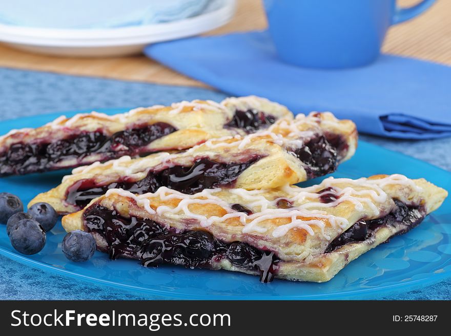 Blueberry turnovers with berries on a platter