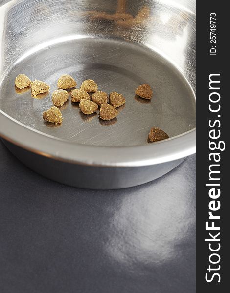 Kibble dog or cat food close up in stainless steel bowl. Kibble dog or cat food close up in stainless steel bowl