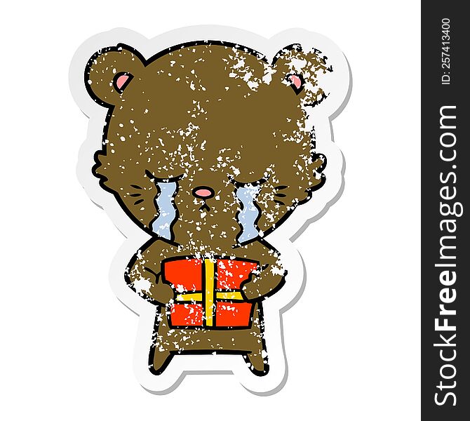 distressed sticker of a crying cartoon bear with present