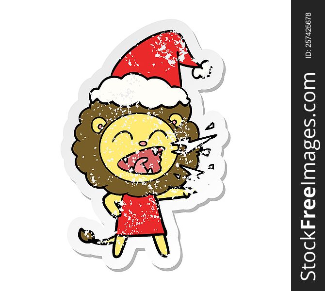 hand drawn distressed sticker cartoon of a roaring lion girl wearing santa hat