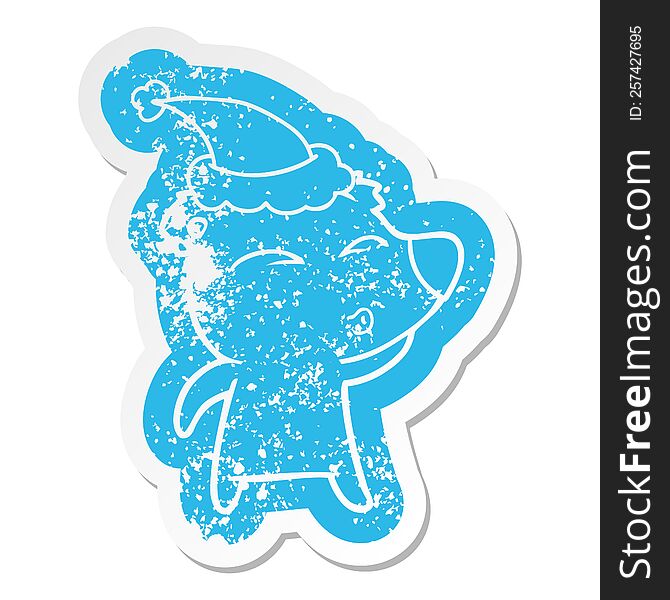 Cartoon Distressed Sticker Of A Whistling Bear Wearing Santa Hat