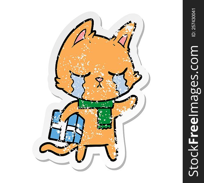 distressed sticker of a crying cartoon cat holding christmas present