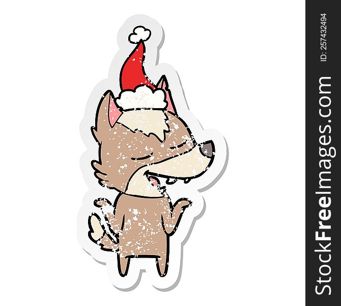 Distressed Sticker Cartoon Of A Wolf Laughing Wearing Santa Hat