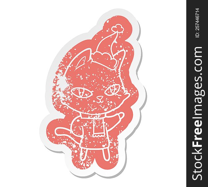 Cartoon Distressed Sticker Of A Cat Staring Wearing Santa Hat