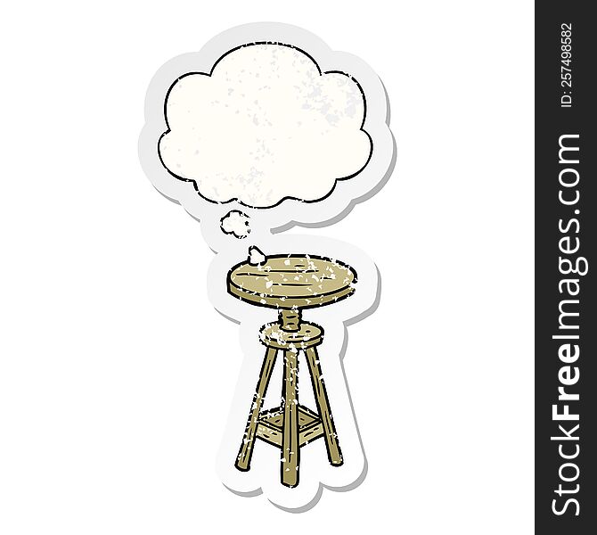 cartoon artist stool with thought bubble as a distressed worn sticker