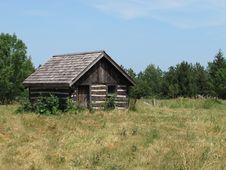 Old Log Shack In A Field. Royalty Free Stock Photo